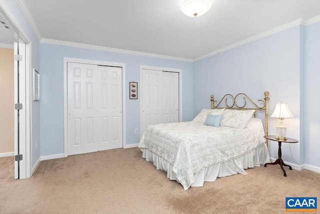 carpeted bedroom featuring crown molding and multiple closets