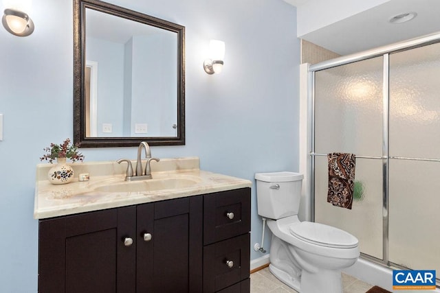 bathroom featuring vanity, tile patterned floors, toilet, and walk in shower