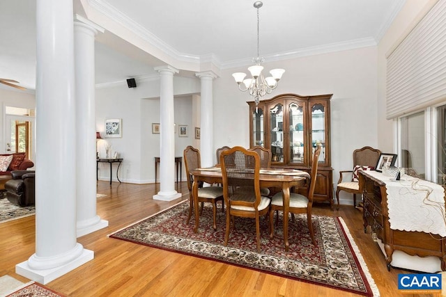 dining room featuring crown molding, an inviting chandelier, and hardwood / wood-style floors