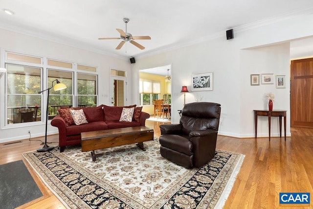 living room with ornamental molding, hardwood / wood-style floors, and ceiling fan