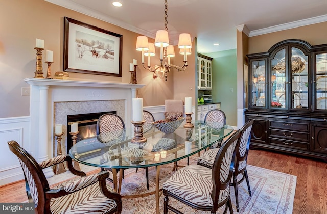 dining room featuring ornamental molding, hardwood / wood-style floors, and a chandelier