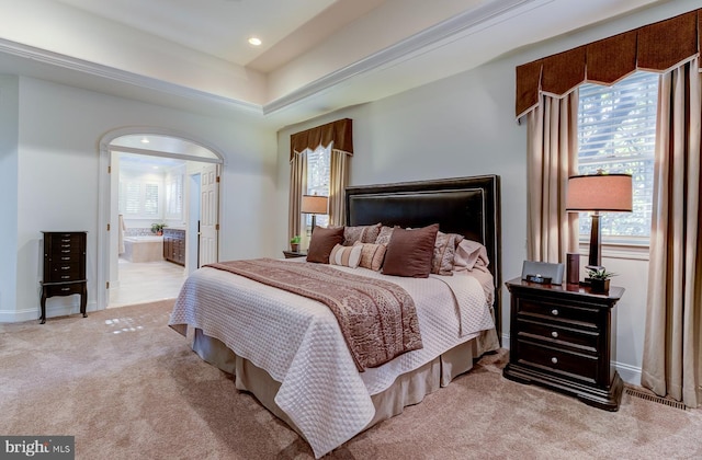 carpeted bedroom featuring ensuite bath