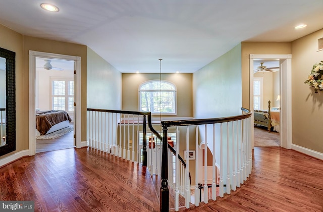 corridor featuring a notable chandelier and hardwood / wood-style floors