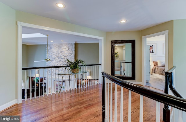 hall featuring crown molding and hardwood / wood-style flooring