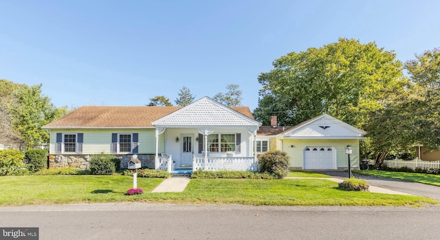 view of front of property with a porch, a front lawn, and a garage