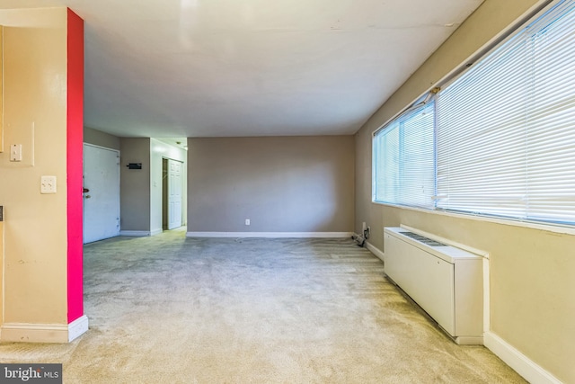 unfurnished room featuring light carpet