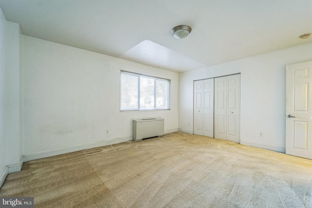 unfurnished bedroom with carpet and a closet