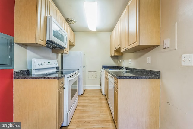 kitchen featuring light brown cabinets, sink, white appliances, and light wood-type flooring