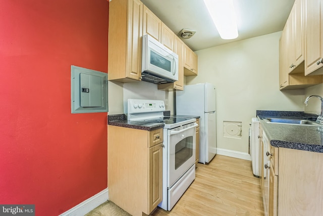 kitchen featuring light brown cabinetry, white appliances, sink, light hardwood / wood-style flooring, and electric panel