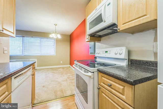 kitchen with decorative light fixtures, white appliances, light hardwood / wood-style flooring, and an inviting chandelier