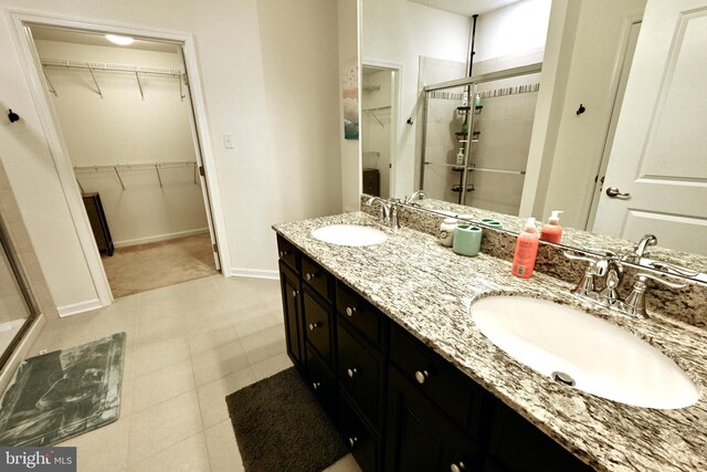 bathroom with vanity, tile patterned floors, and a shower with door