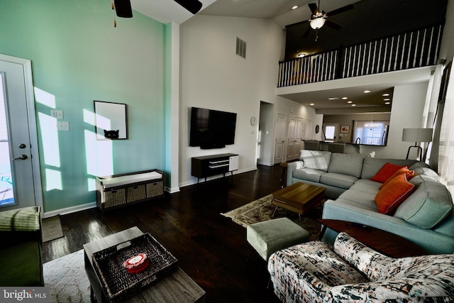 living room featuring high vaulted ceiling, plenty of natural light, and dark hardwood / wood-style floors