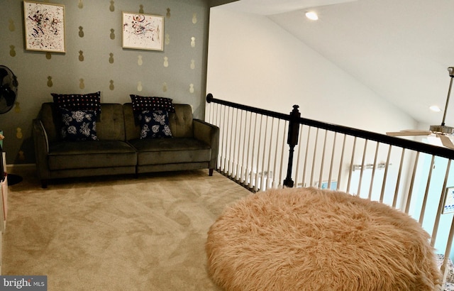 sitting room with ceiling fan, light colored carpet, and vaulted ceiling