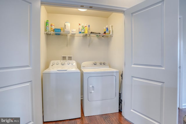 laundry area featuring washing machine and dryer and hardwood / wood-style floors