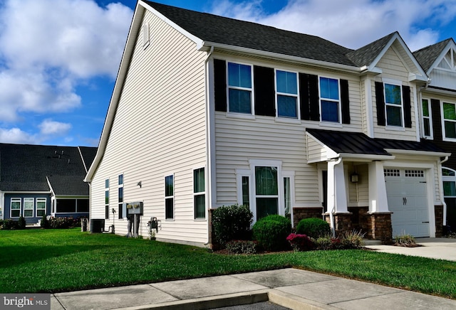 view of front of house featuring a front yard and a garage