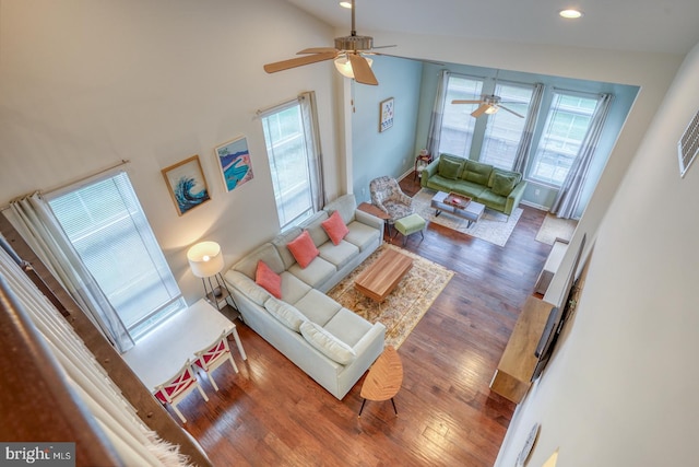 living room with dark hardwood / wood-style floors, high vaulted ceiling, and ceiling fan