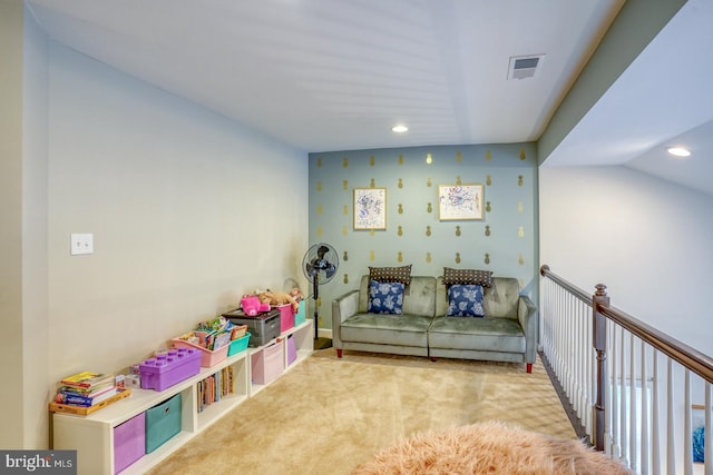 rec room with vaulted ceiling and light carpet