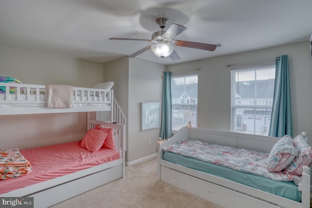 bedroom featuring light carpet and ceiling fan