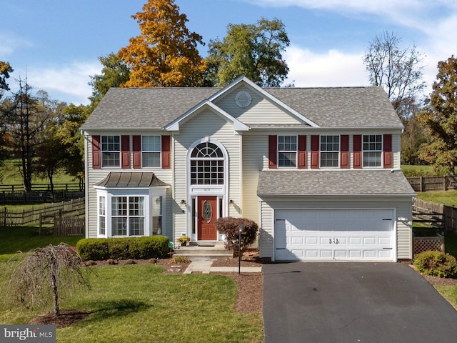 view of front of property with a garage and a front yard