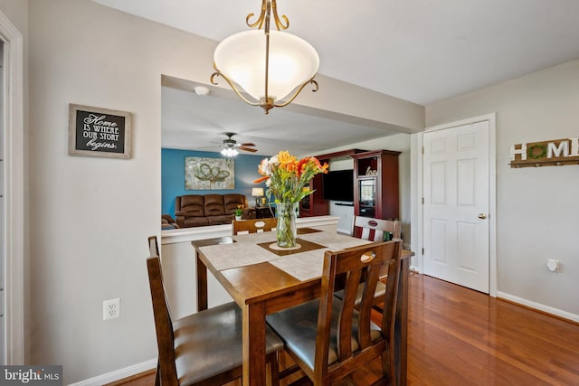 dining room featuring ceiling fan and dark hardwood / wood-style flooring