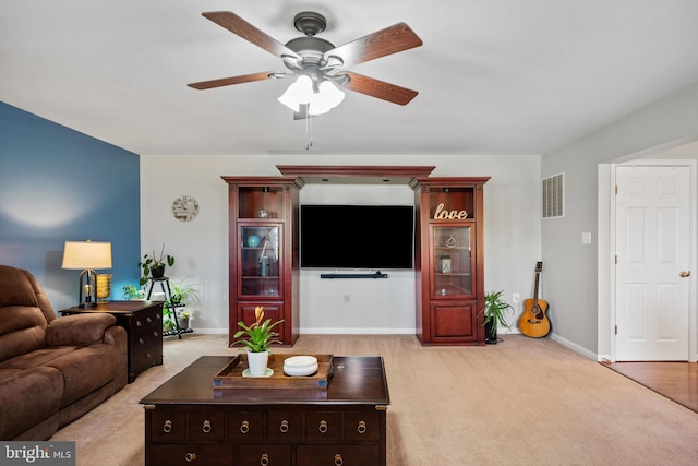 carpeted living room with ceiling fan