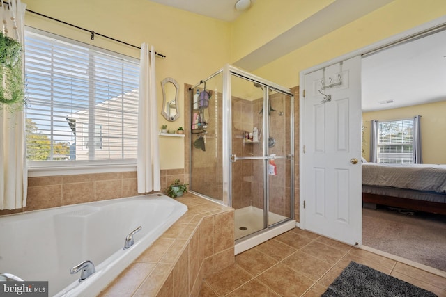 bathroom with shower with separate bathtub and tile patterned floors