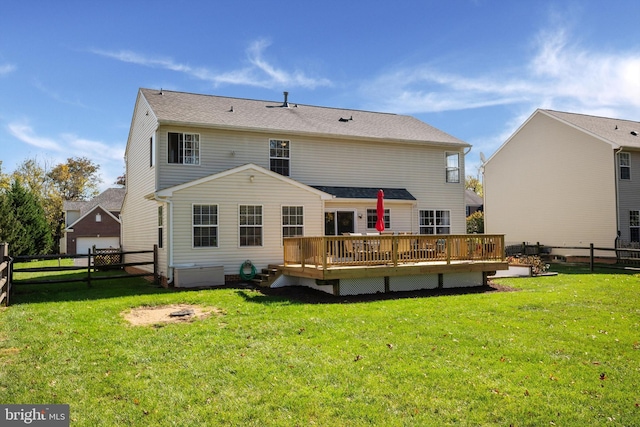 back of house with a yard and a deck