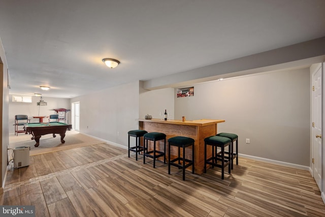 bar featuring hardwood / wood-style floors and billiards