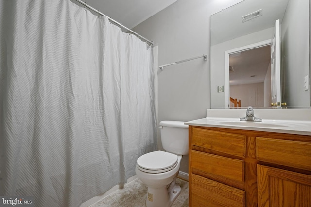 bathroom featuring tile patterned floors, vanity, and toilet