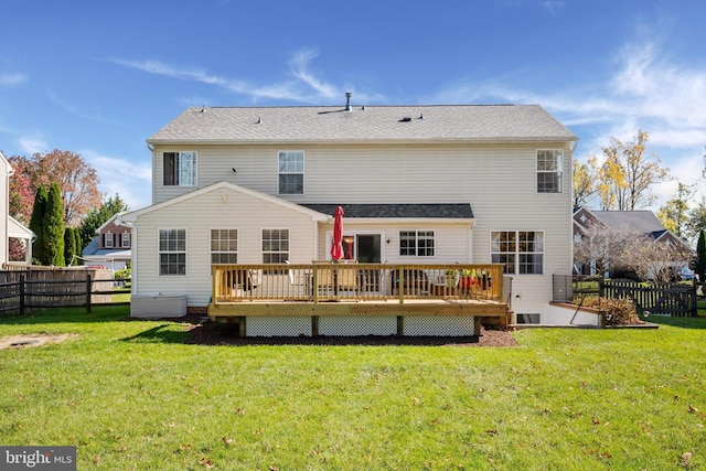 rear view of property with a yard and a deck