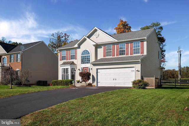 view of front facade featuring central AC, a garage, and a front yard