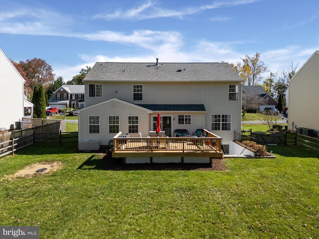 rear view of property featuring a yard and a deck