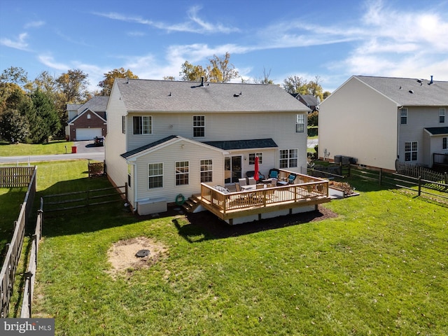 back of property with a wooden deck and a yard