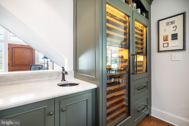 interior space featuring green cabinets, sink, and dark hardwood / wood-style flooring