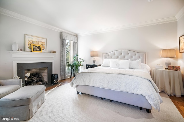 bedroom with ornamental molding and wood-type flooring