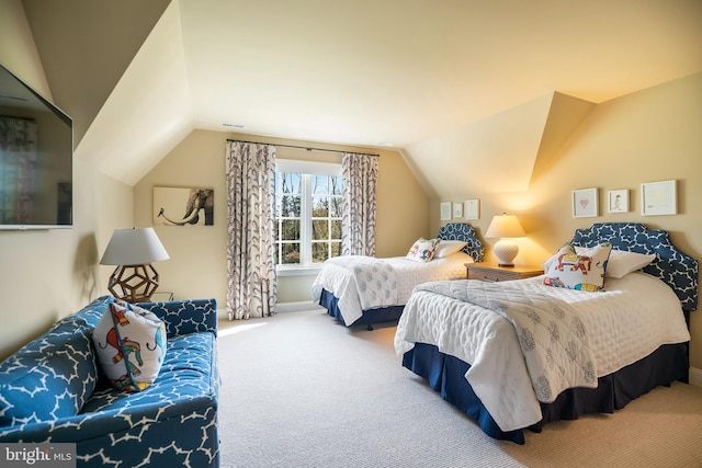 bedroom featuring lofted ceiling and carpet