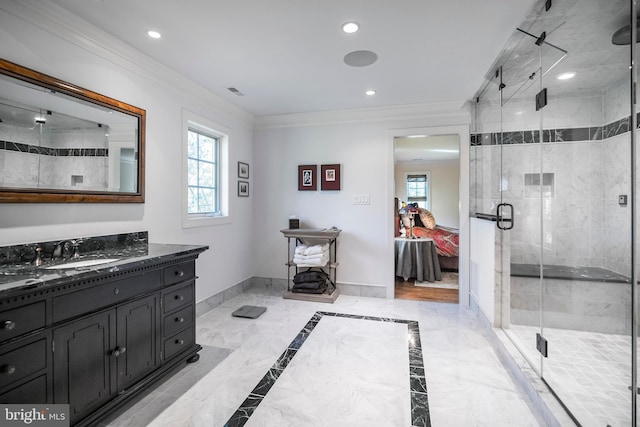 bathroom featuring vanity, ornamental molding, and an enclosed shower