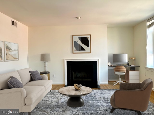 living room with a healthy amount of sunlight and light hardwood / wood-style flooring