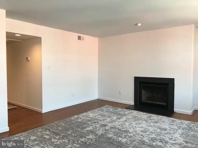 unfurnished living room featuring dark hardwood / wood-style floors