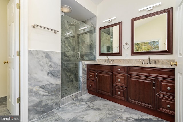 bathroom featuring vanity and an enclosed shower