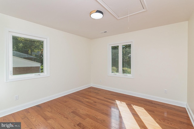 unfurnished room with hardwood / wood-style floors