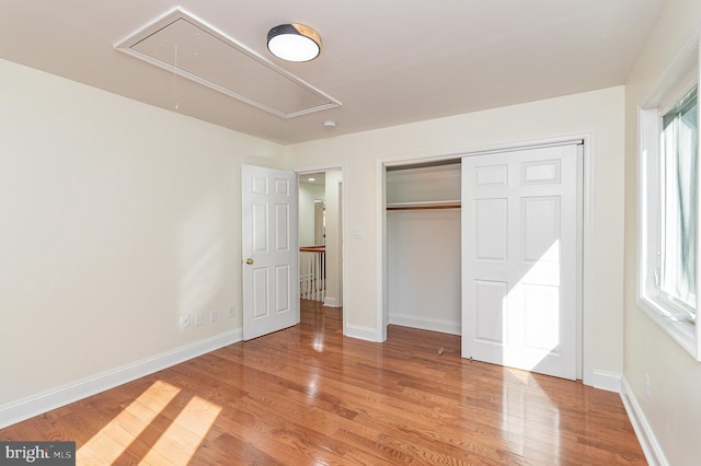 unfurnished bedroom featuring a closet and light wood-type flooring