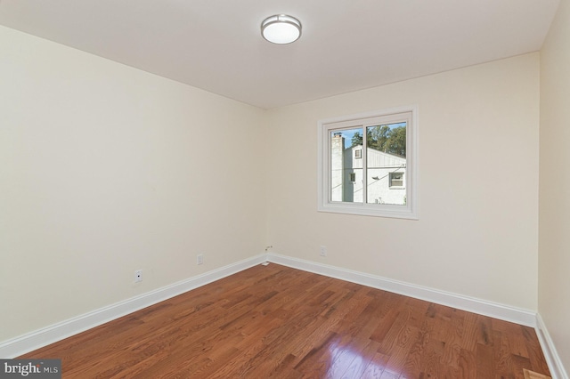 spare room with wood-type flooring