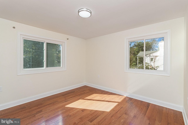 empty room with hardwood / wood-style floors