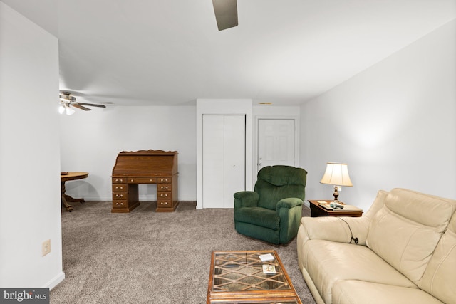 carpeted living room with ceiling fan