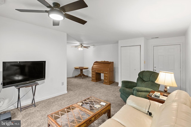 living room featuring carpet flooring and ceiling fan