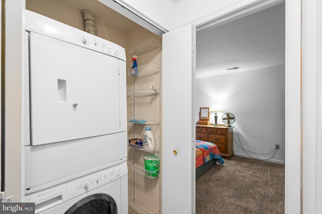 washroom with carpet and stacked washing maching and dryer