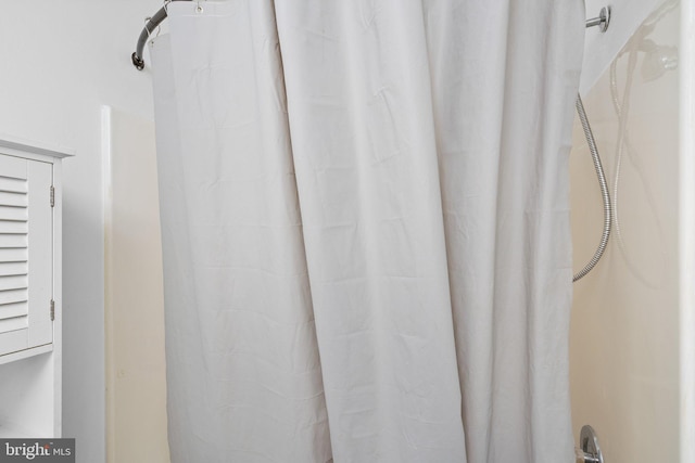 interior details featuring a shower with curtain