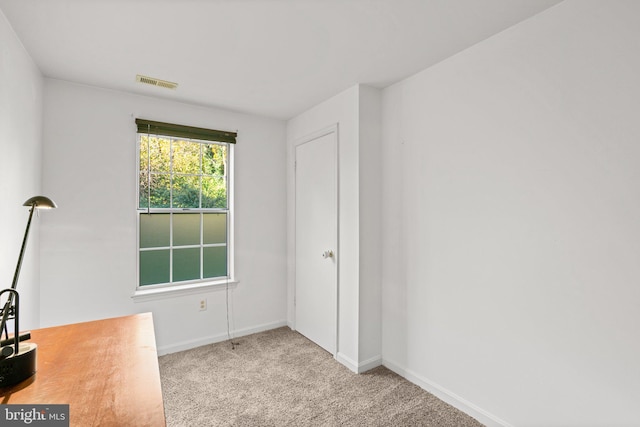 spare room with light colored carpet