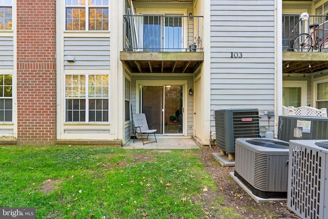 doorway to property with a balcony and cooling unit